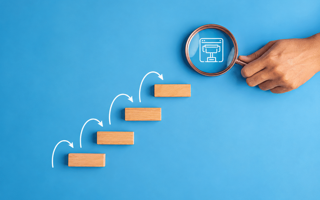 Alt text: Hand holding a magnifying glass over a digital interface, with ascending wooden blocks and arrows symbolizing technological progress, analysis, and continuous improvement.
